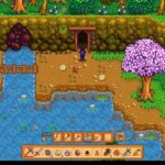 Pixel art game scene: a character stands at a cave entrance beside a small waterfall and a pink-leaved tree, in a colorful forest setting.