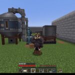 Minecraft player standing in a grassy yard beside industrial machines: a large blue processing unit on stilts connected by pipes, with a gray reactor nearby and a stone wall to the right.