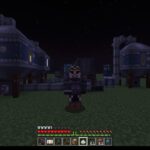 Minecraft character stands on grassy terrain at night with blue modular buildings behind, inventory and health bar visible at bottom.