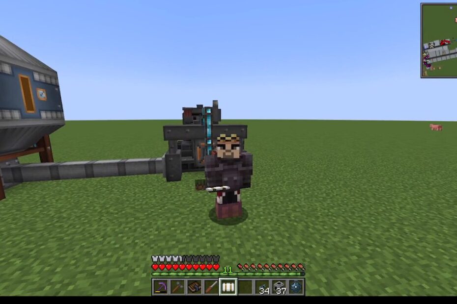 Minecraft player in dark armor holds a pickaxe, standing in front of a large processing machine on a flat grassy world; HUD visible on screen.